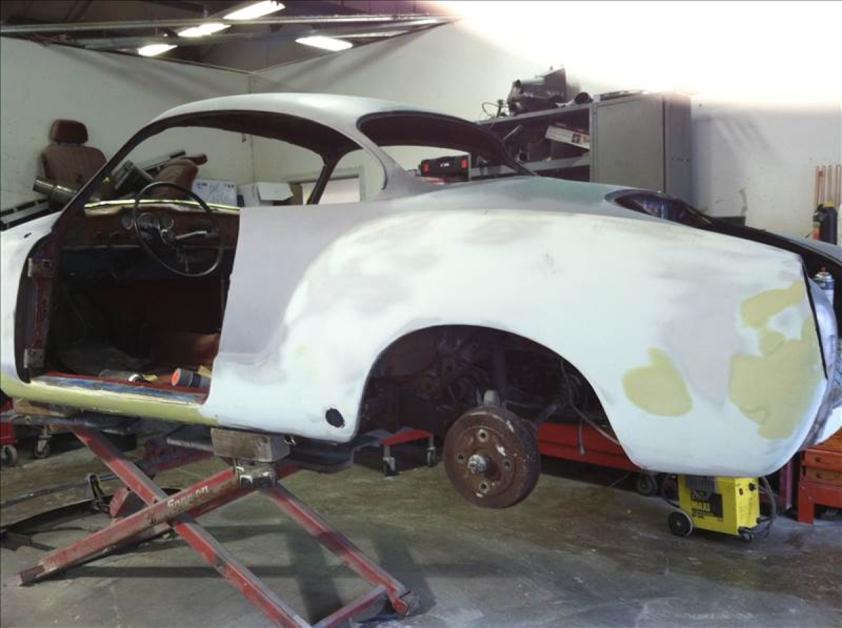A vehicle undergoing bodywork and paint prep inside Columbia Auto Collision Center's shop